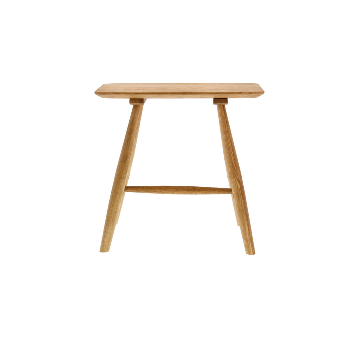 Light brown wooden stool with a rectangular seat and slightly tapered legs.