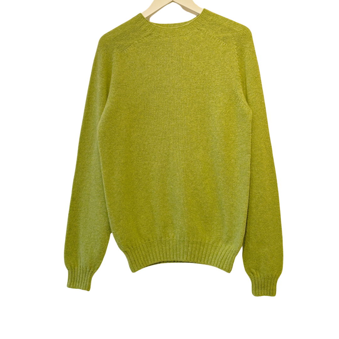 Lime green crewneck sweater with long sleeves, hanging on a wooden hanger.