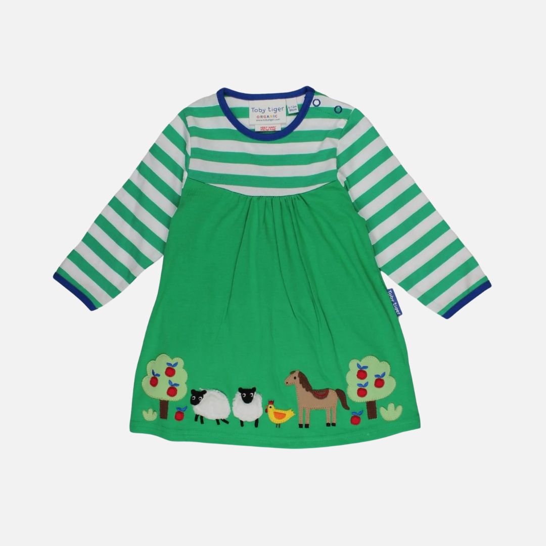A short-sleeved green dress with a striped bodice and farmyard animal applique on the bottom edge, labeled with the brand Toby Tiger.