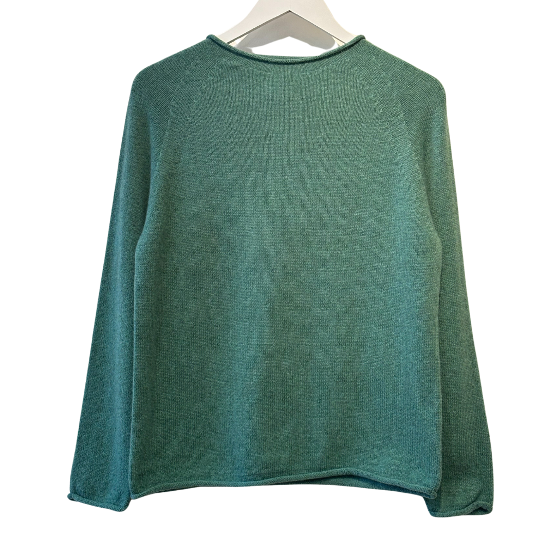 Seafoam green raglan-sleeve sweater, knit from a textured yarn, shown on a hanger.