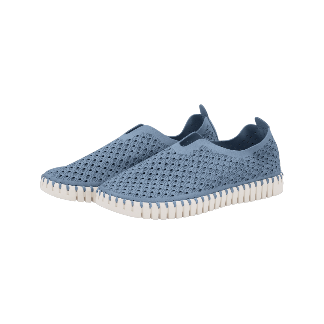 Pair of blue slip-on shoes with a textured, perforated upper and off-white sole.