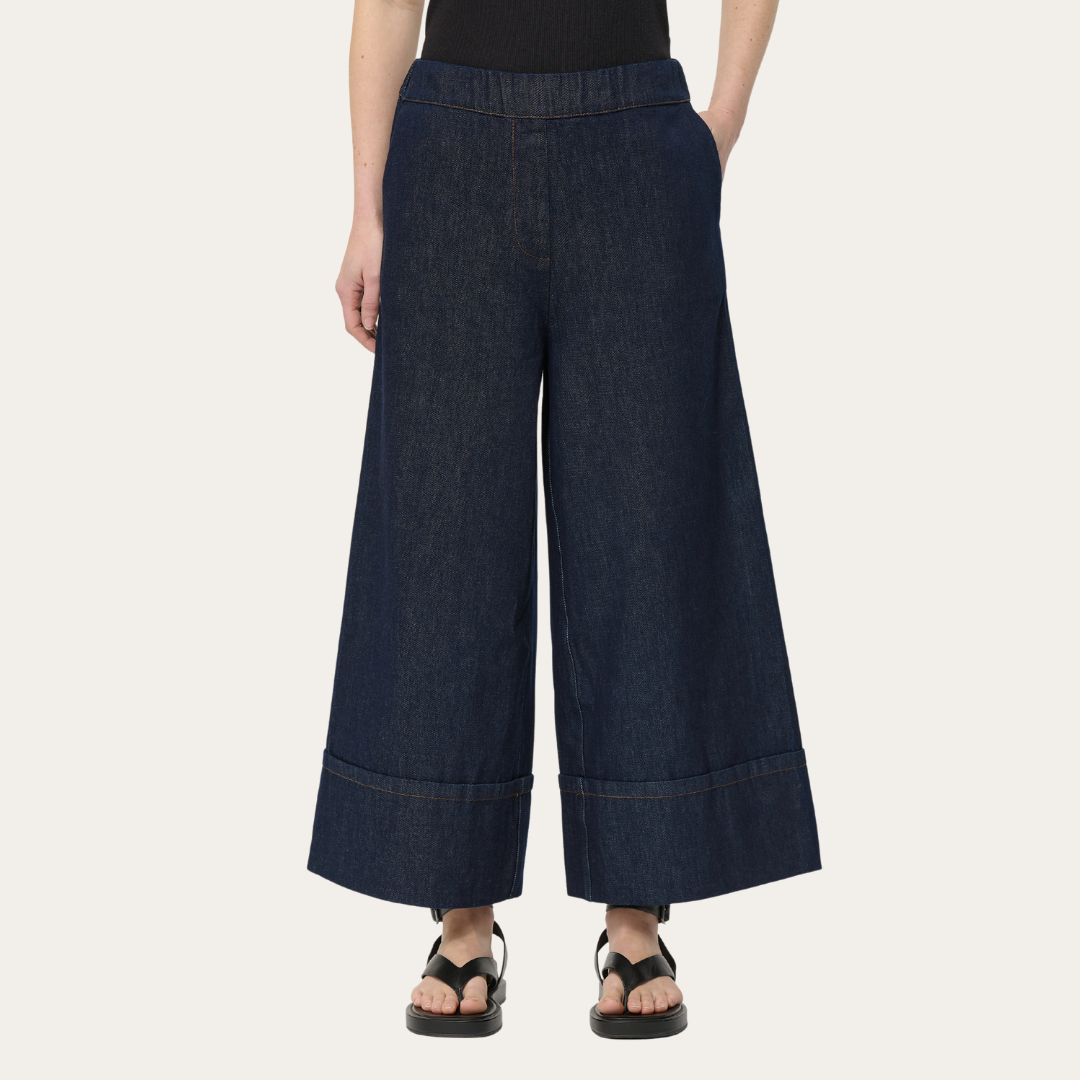 Dark wash denim wide-leg pants with cuffed hems and an elastic waistband.