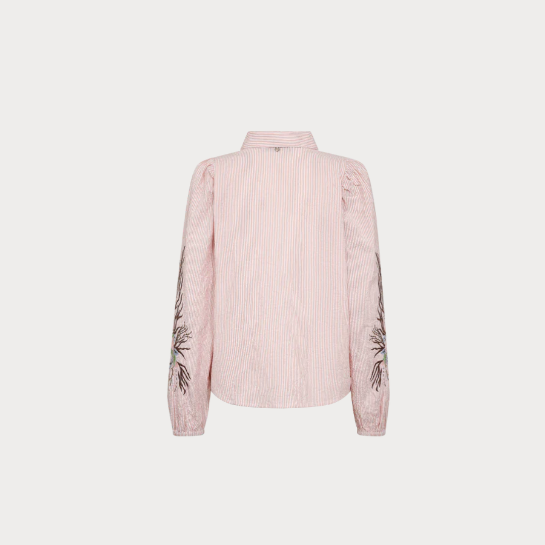 Pink blouse with embroidery on sleeves against a light gray background