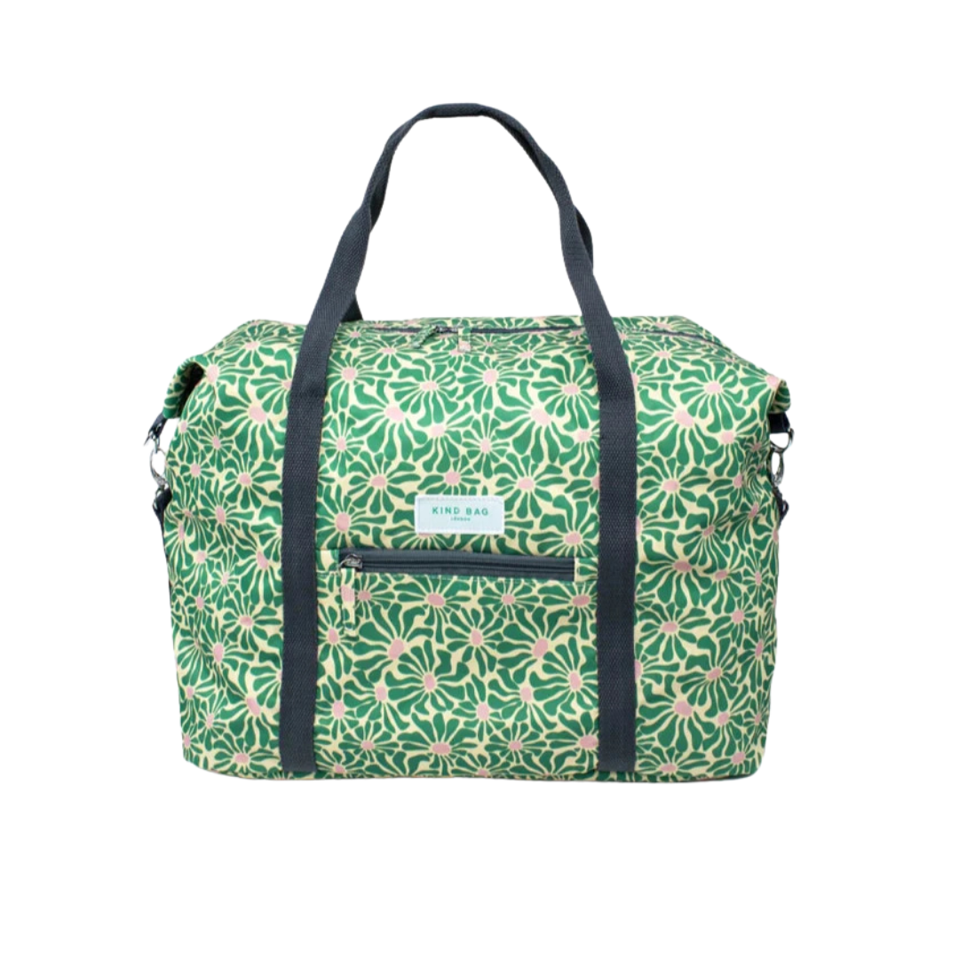 Green and beige floral-print duffel bag with black handles and zippered front pocket.