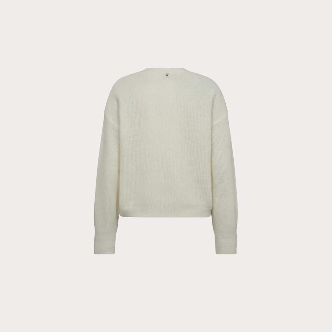 White sweater on a light beige background