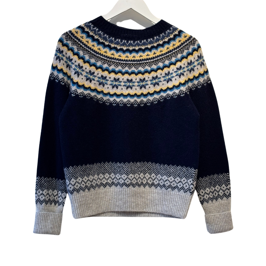 Navy blue crewneck wool sweater with a Fair Isle-style yoke and hem in grey, blue, and yellow.