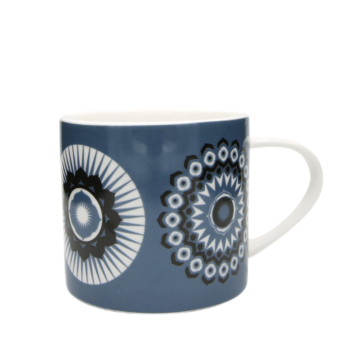 Blue mug with white handle and black and white mandala-style patterns.