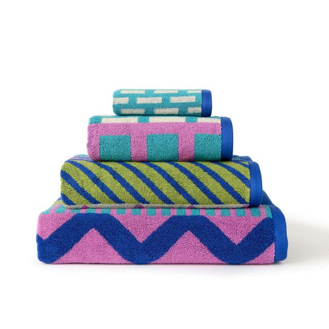 Set of colorful towels with geometric patterns on a white background