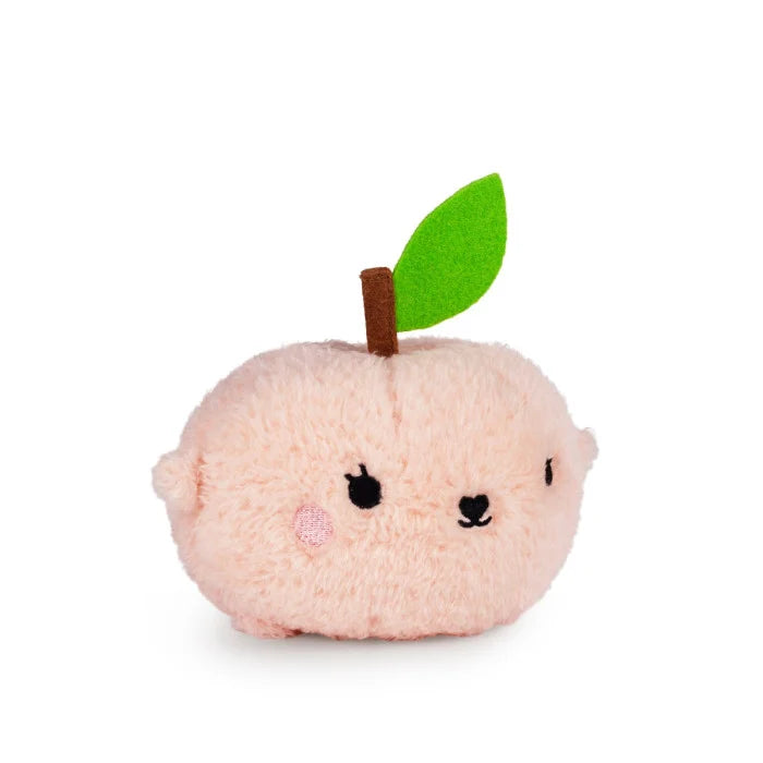 Plush toy shaped like a peach with a green leaf on a white background