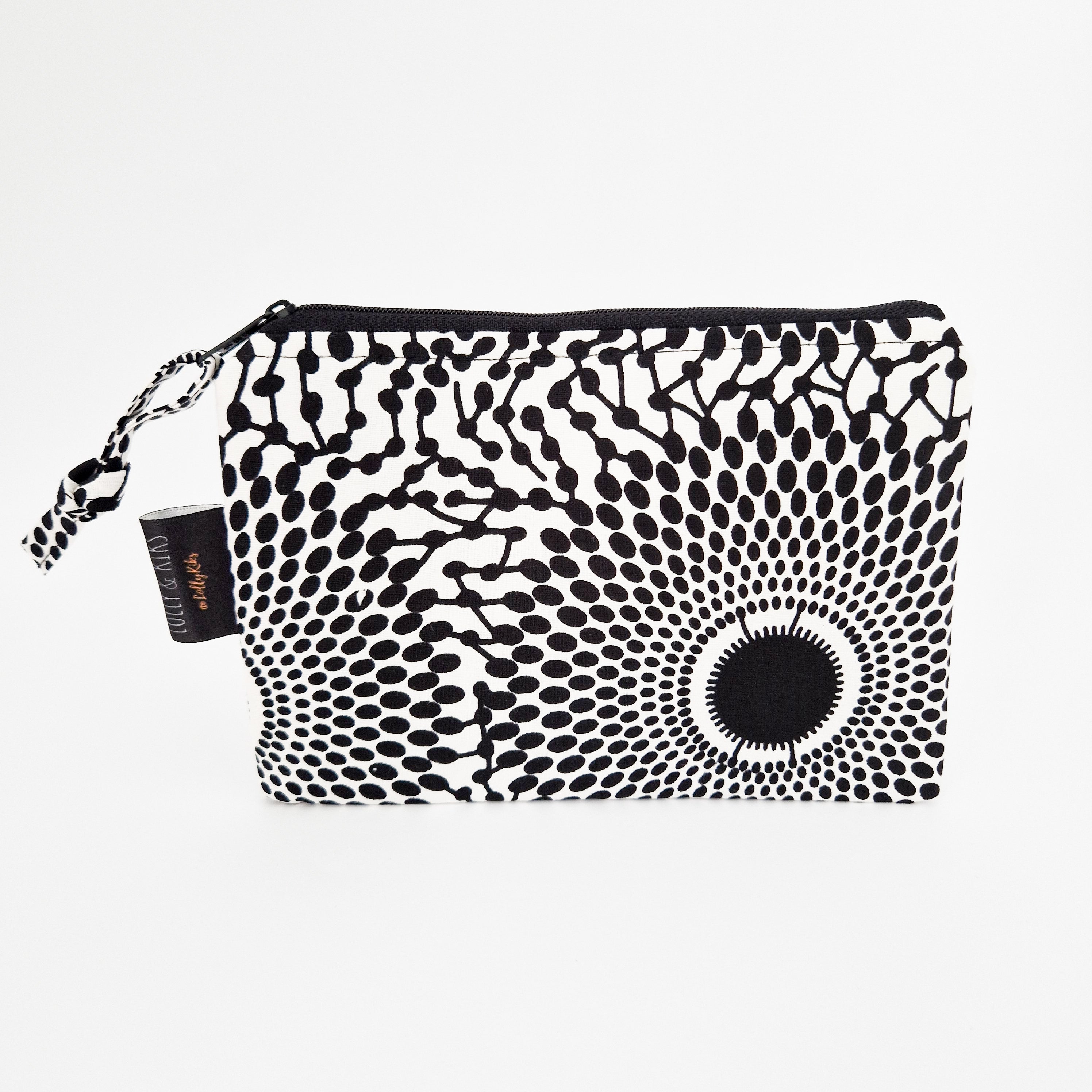 Black and white zippered pouch with a radiating circular pattern of dots and lines.