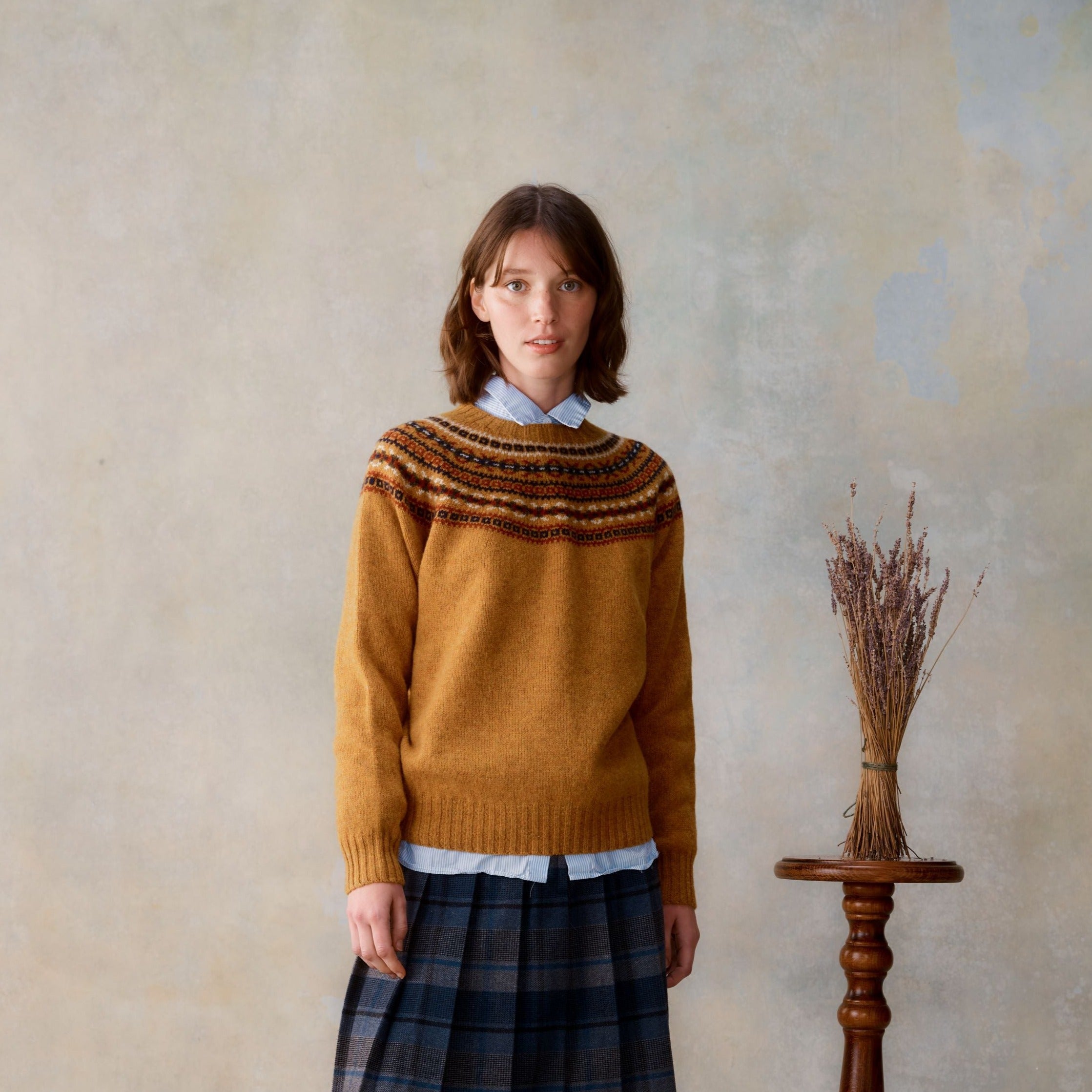Mustard yellow wool sweater with a Fair Isle-style yoke.