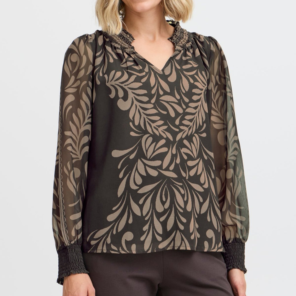 Fransa blouse in dark green with cream leaf pattern, featuring a smocked neckline and long sleeves.