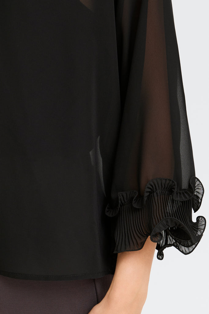 Black sheer blouse by Fransa with pleated ruffled cuffs, featuring a smooth finish. Perfect for elegant occasions.