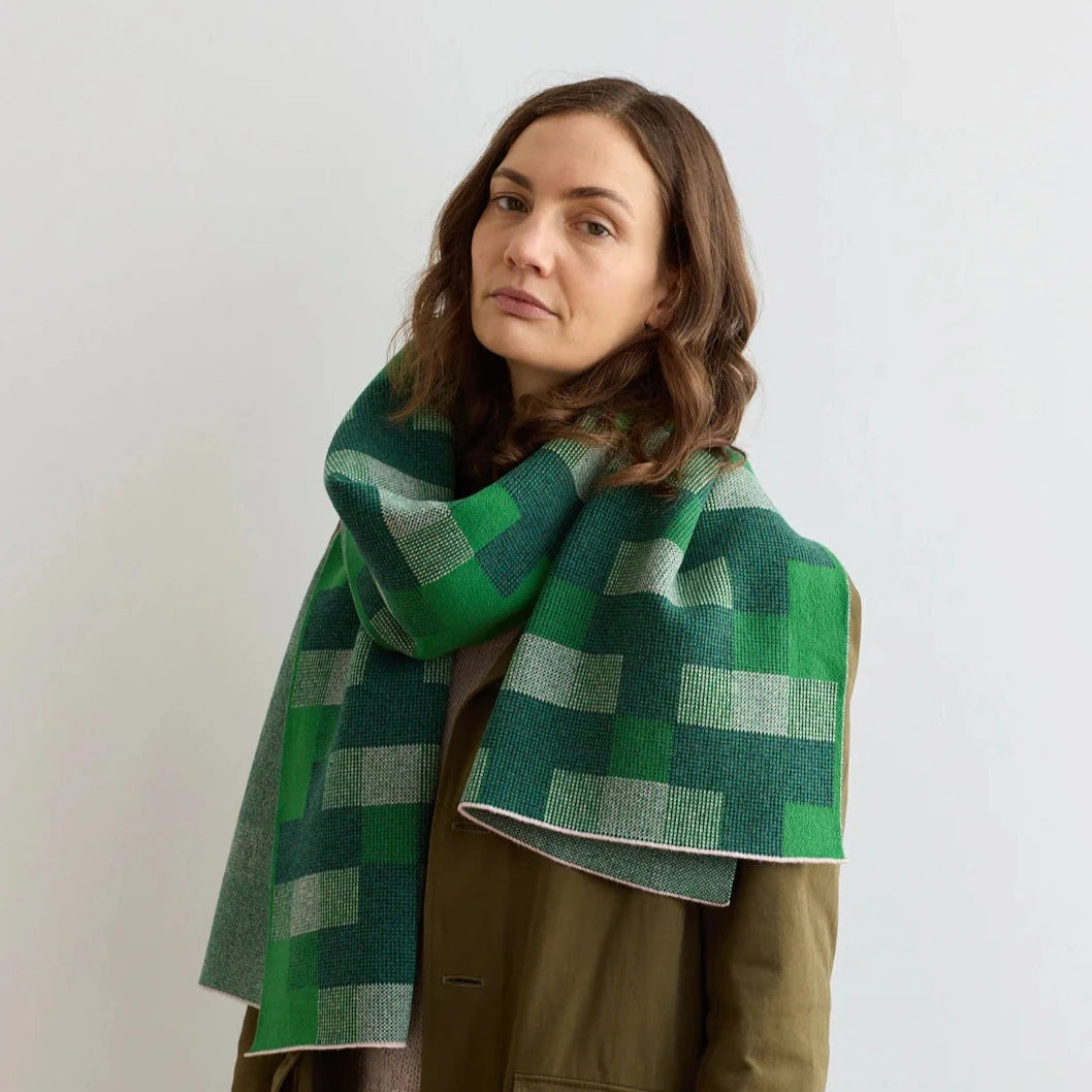 Green and gray geometric patterned wool scarf.  Knitted texture.