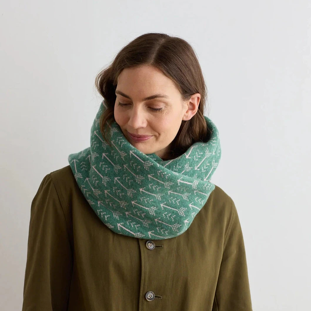 Seafoam green knitted cowl neck warmer with a pale pink arrow pattern.