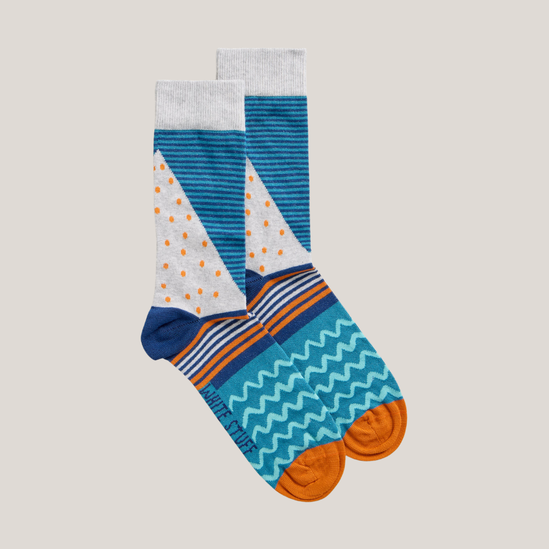 Pair of blue, orange, and grey patterned socks with a sailboat design.