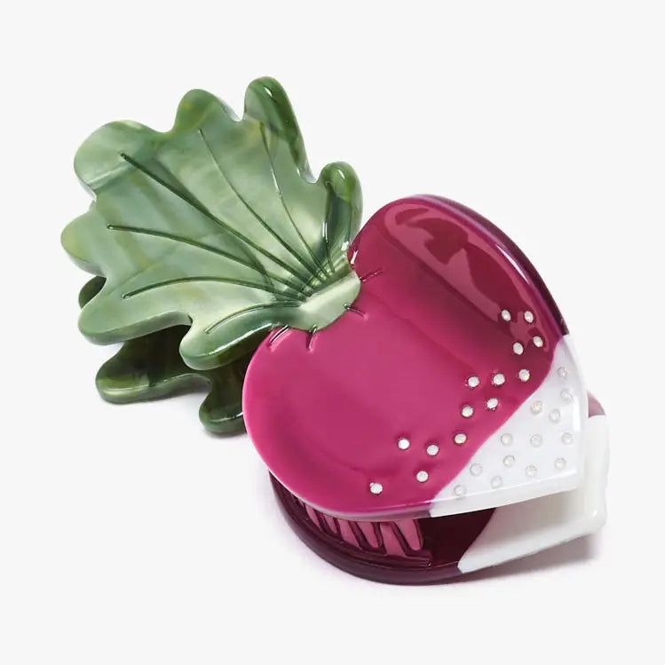Pink and green kitchen tool on a white background