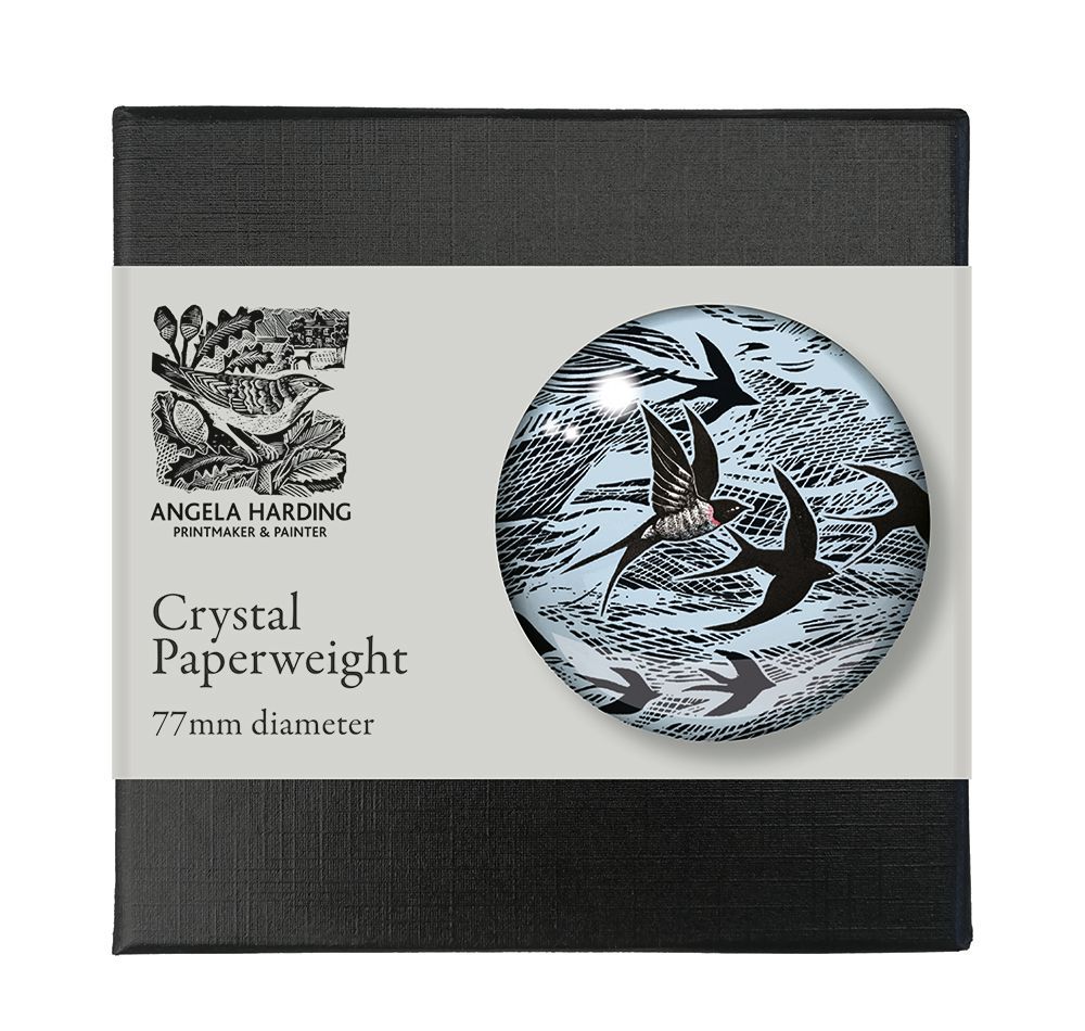 77mm diameter crystal paperweight featuring an Angela Harding design of birds in flight, black silhouettes on a light blue