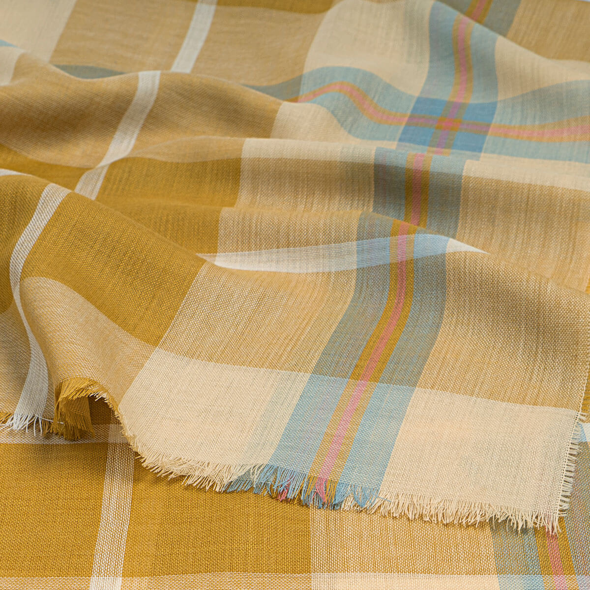 Plaid fabric with yellow, blue, and pink colours