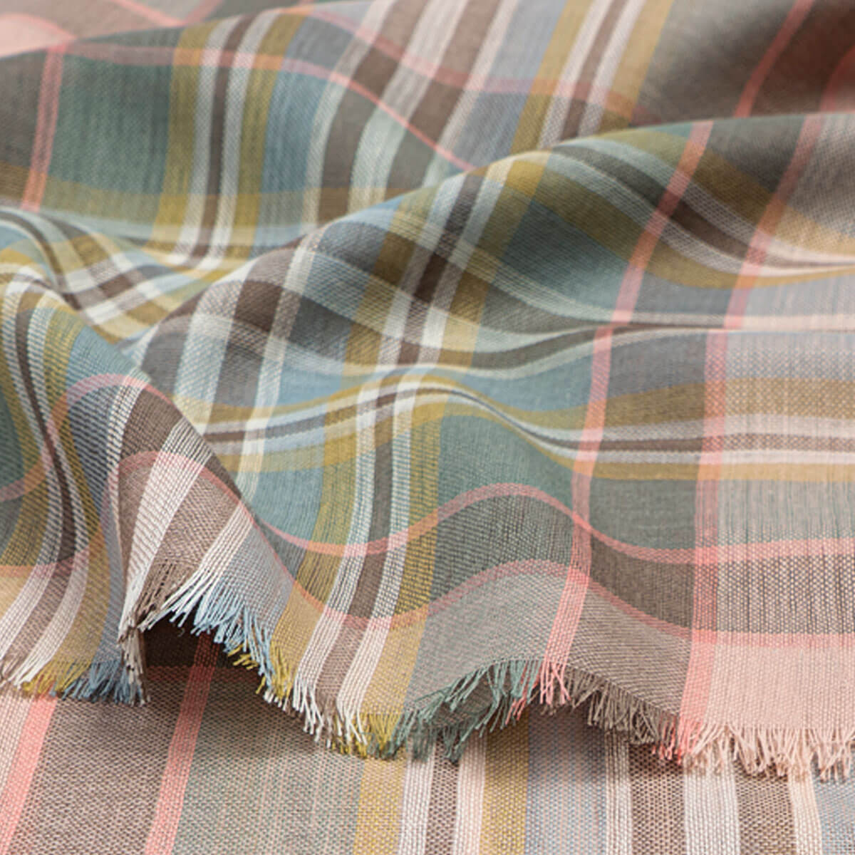 Plaid material with pink, green and grey colours