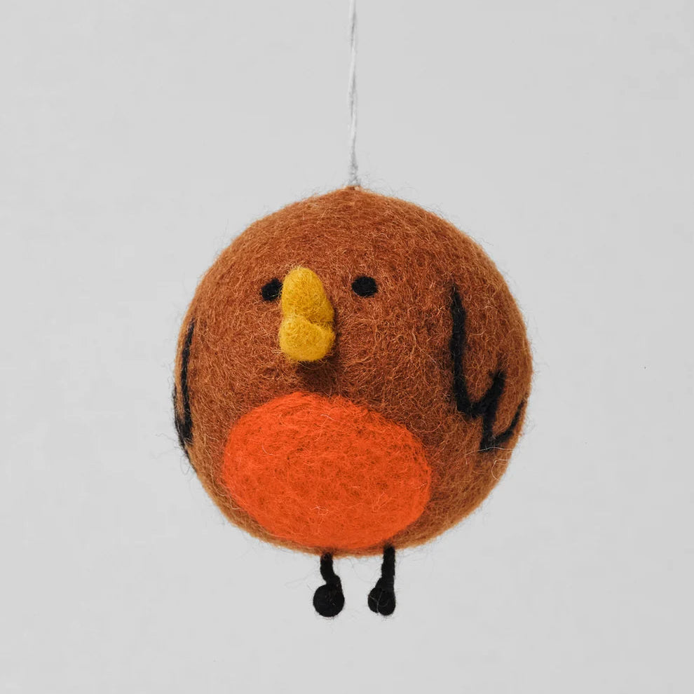 A brown felt bird ornament with a yellow beak, orange belly, and black details, hanging against a light gray background.