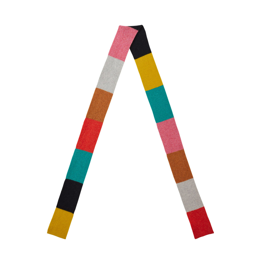 Colorful scarf by Donna Wilson featuring pink, teal, gray, black, yellow, orange, and red stripes.