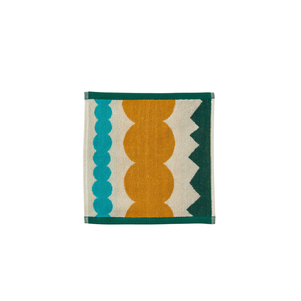 Colourful Donna Wilson towel featuring teal, mustard yellow, off-white, and dark green geometric patterns.