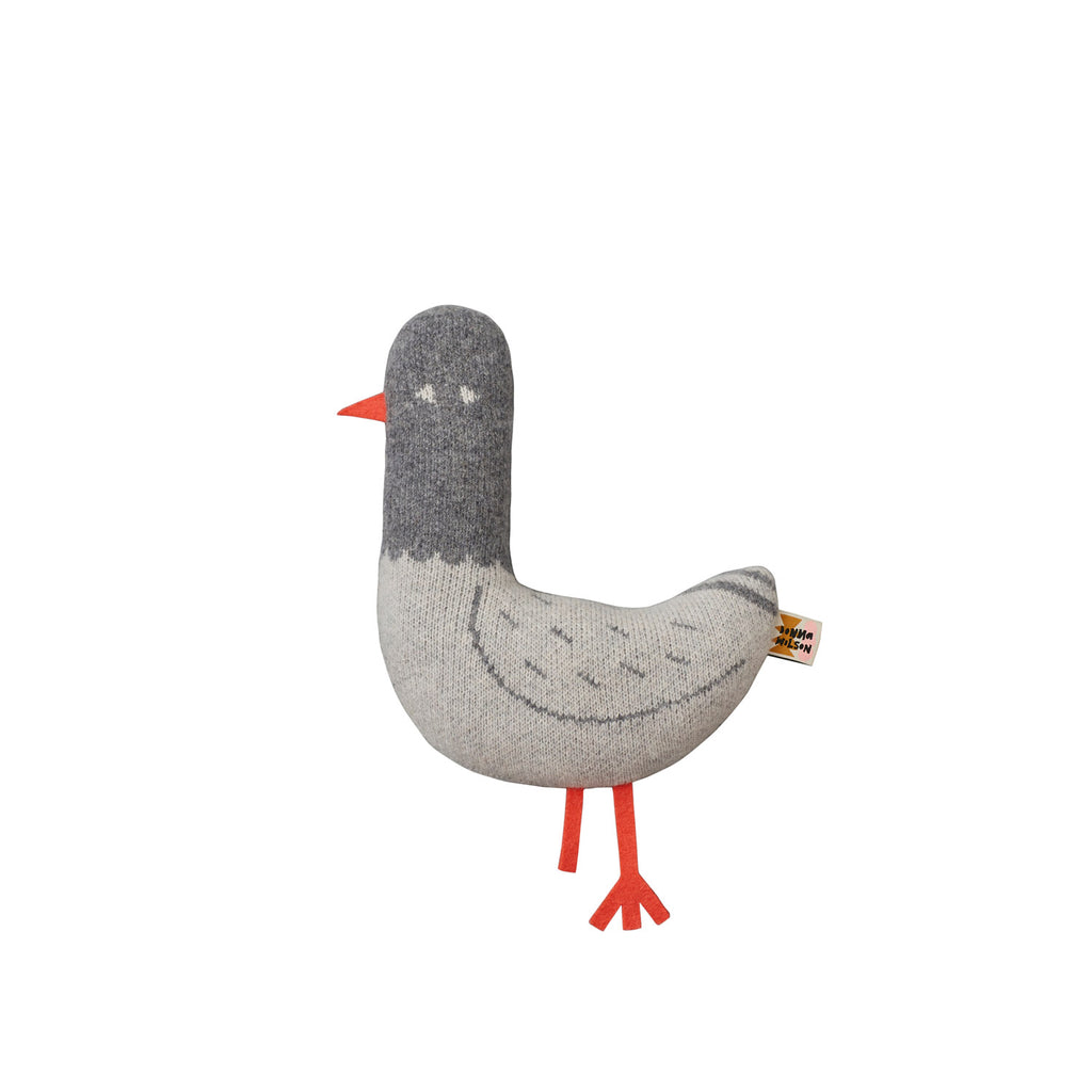 Stuffed bird by Donna Wilson, featuring gray body, orange beak, and legs. Soft, playful design.