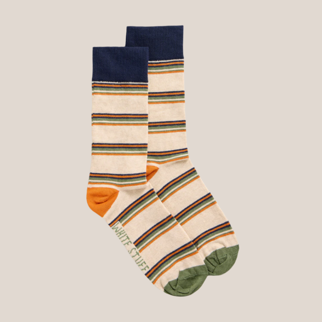 Pair of cream crew socks with orange, green, and navy stripes.