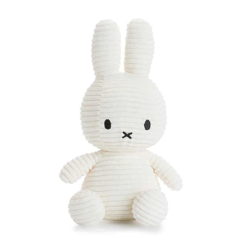 Cream-colored corduroy Miffy plush toy sitting down.  Simple black embroidered facial features.