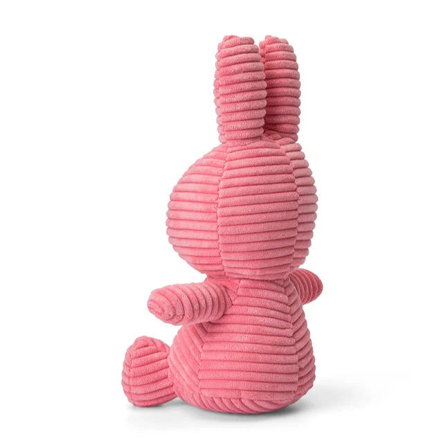 Pink corduroy Miffy rabbit plush toy, sitting.