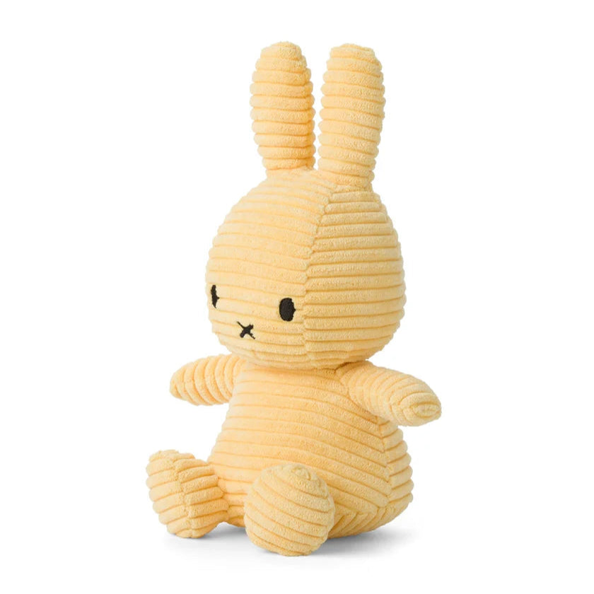 Pale yellow corduroy Miffy plush toy sitting down.