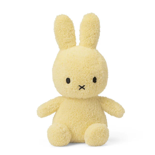 Yellow plush bunny toy on a white background
