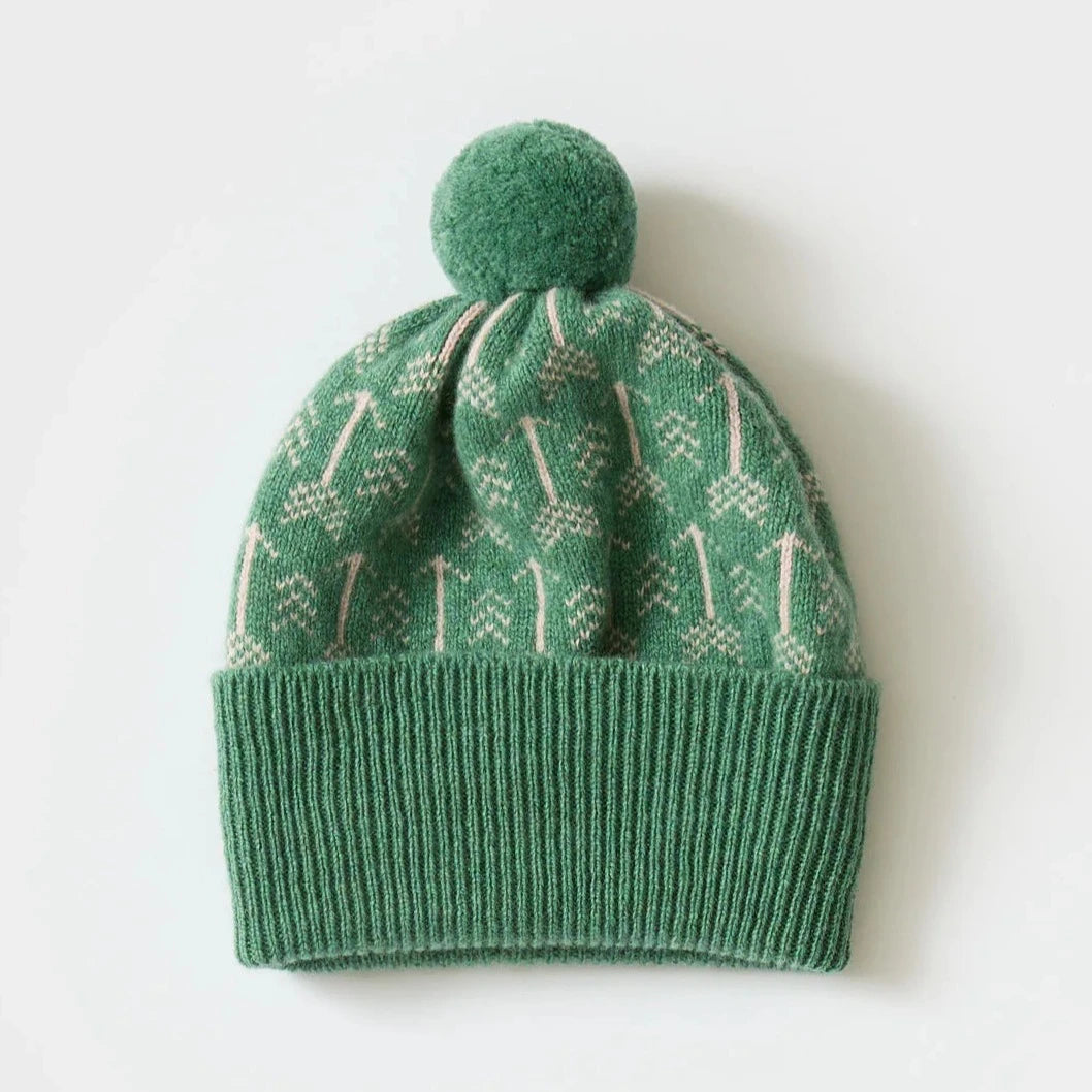 Green knitted beanie with a pom-pom and a Fair Isle-style pattern in cream.