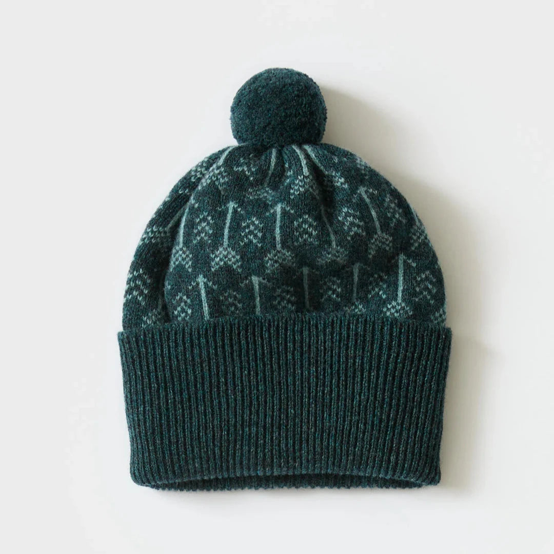 Dark teal knitted beanie with a pompom and a light teal repeating pattern.