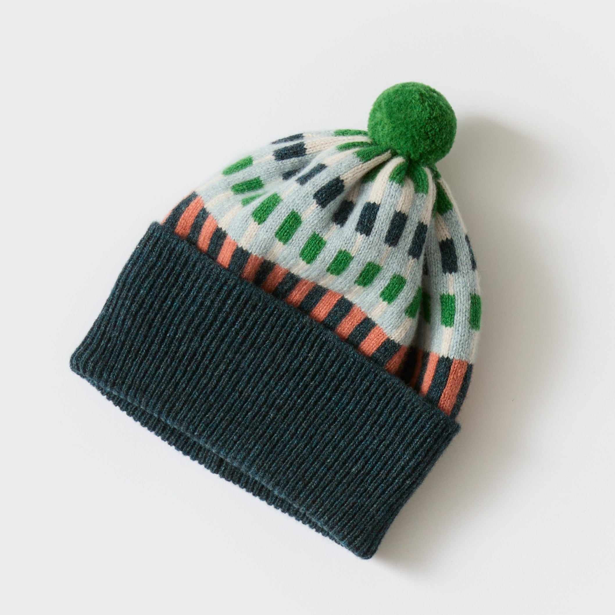 Knit beanie with a green pompom.