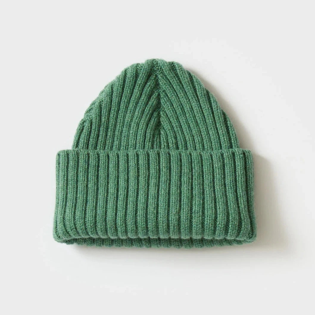 Seamless green ribbed knit beanie.