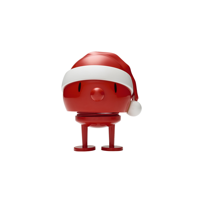 Red, stylized Christmas figure wearing a Santa hat.  The figure has a round body, small legs, and a simple face.