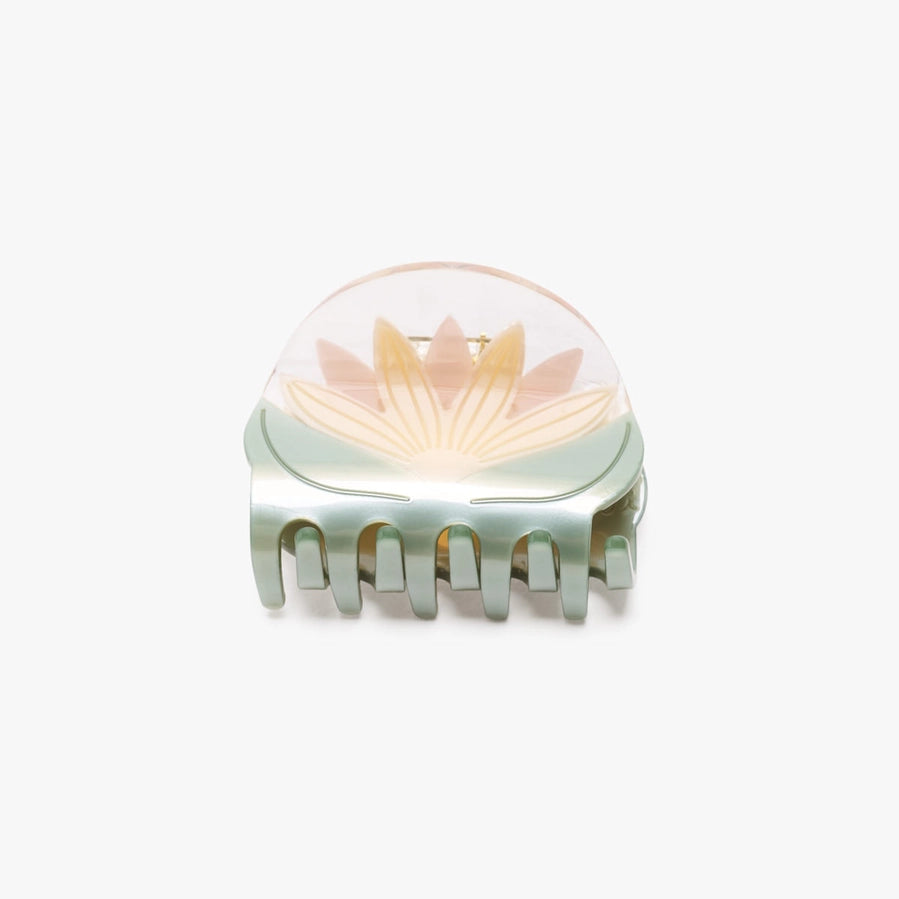 A translucent hair claw clip featuring a lotus flower design in soft pastel tones of peach, yellow, and mint green on a white background.