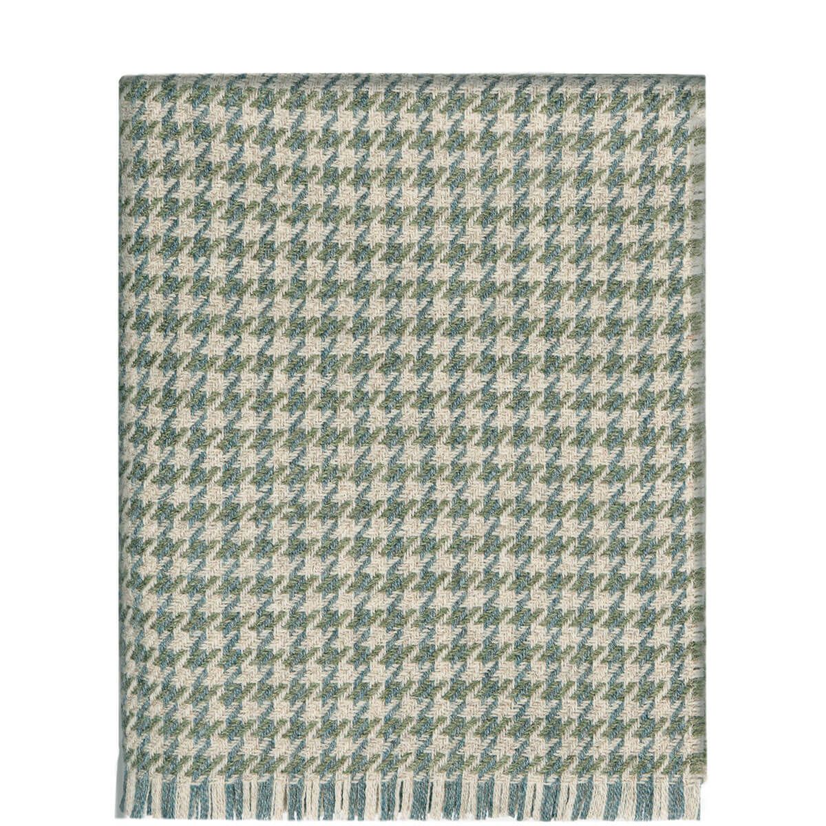Woven throw blanket in a green and beige houndstooth pattern with fringed edges.