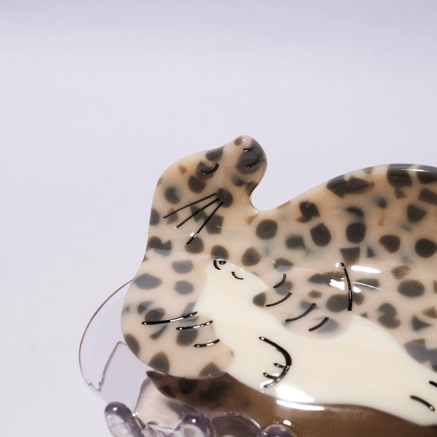 Leopard print seal-shaped hair clip on a white background