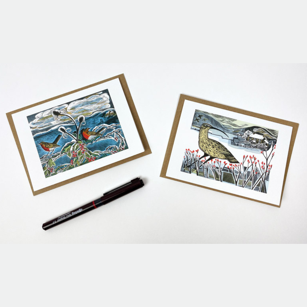 Two linocut-style Christmas cards featuring winter bird scenes.