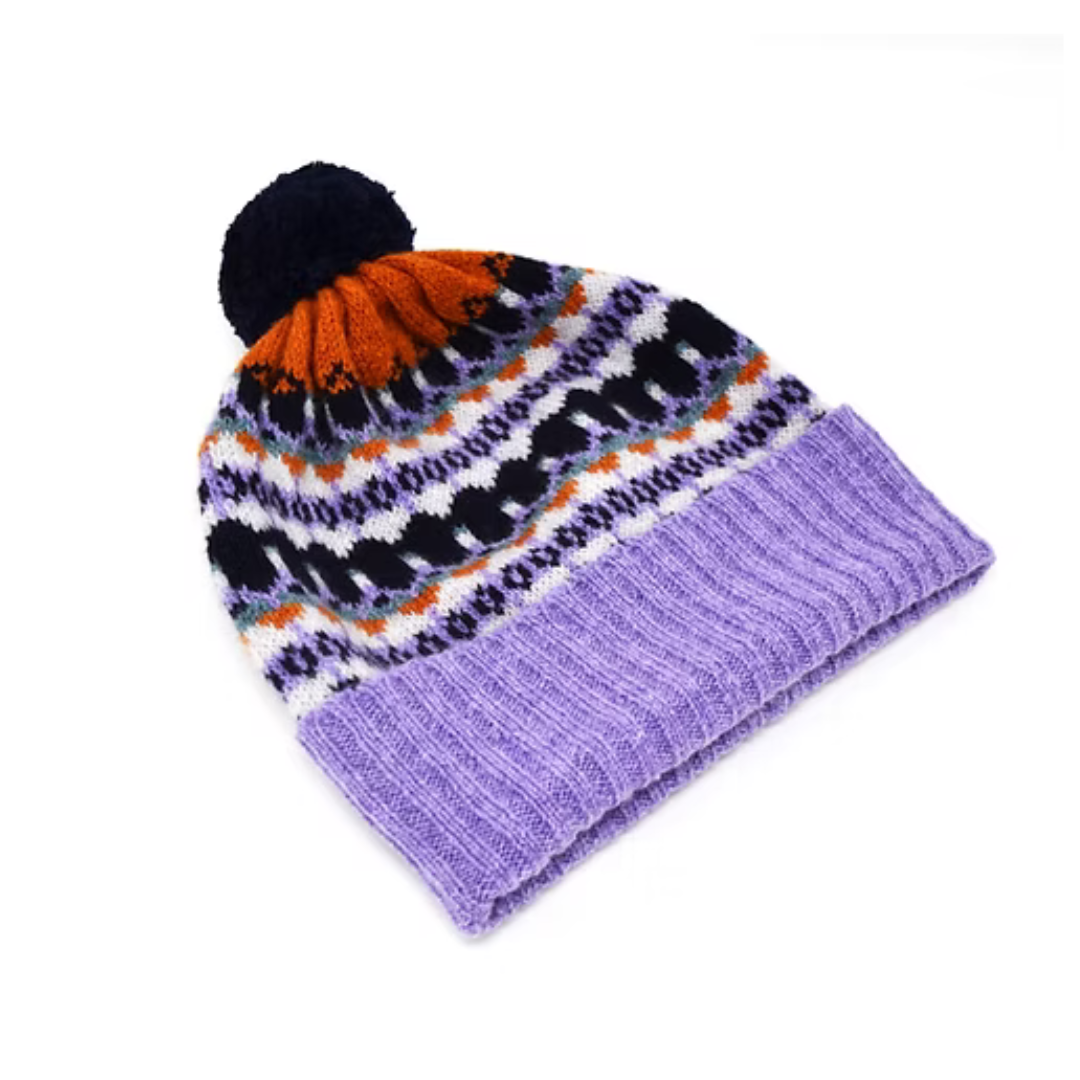 Purple knitted beanie with a fair isle pattern crown and a dark blue pompom.