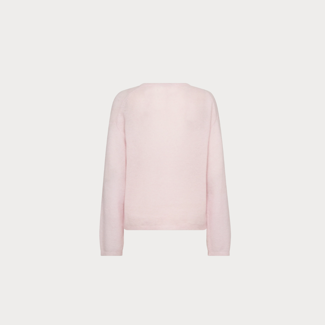 Light pink sweater on a light gray background