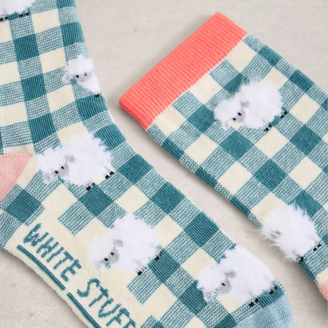 Checkered socks with sheep design and 'White Stuff' branding on a neutral background