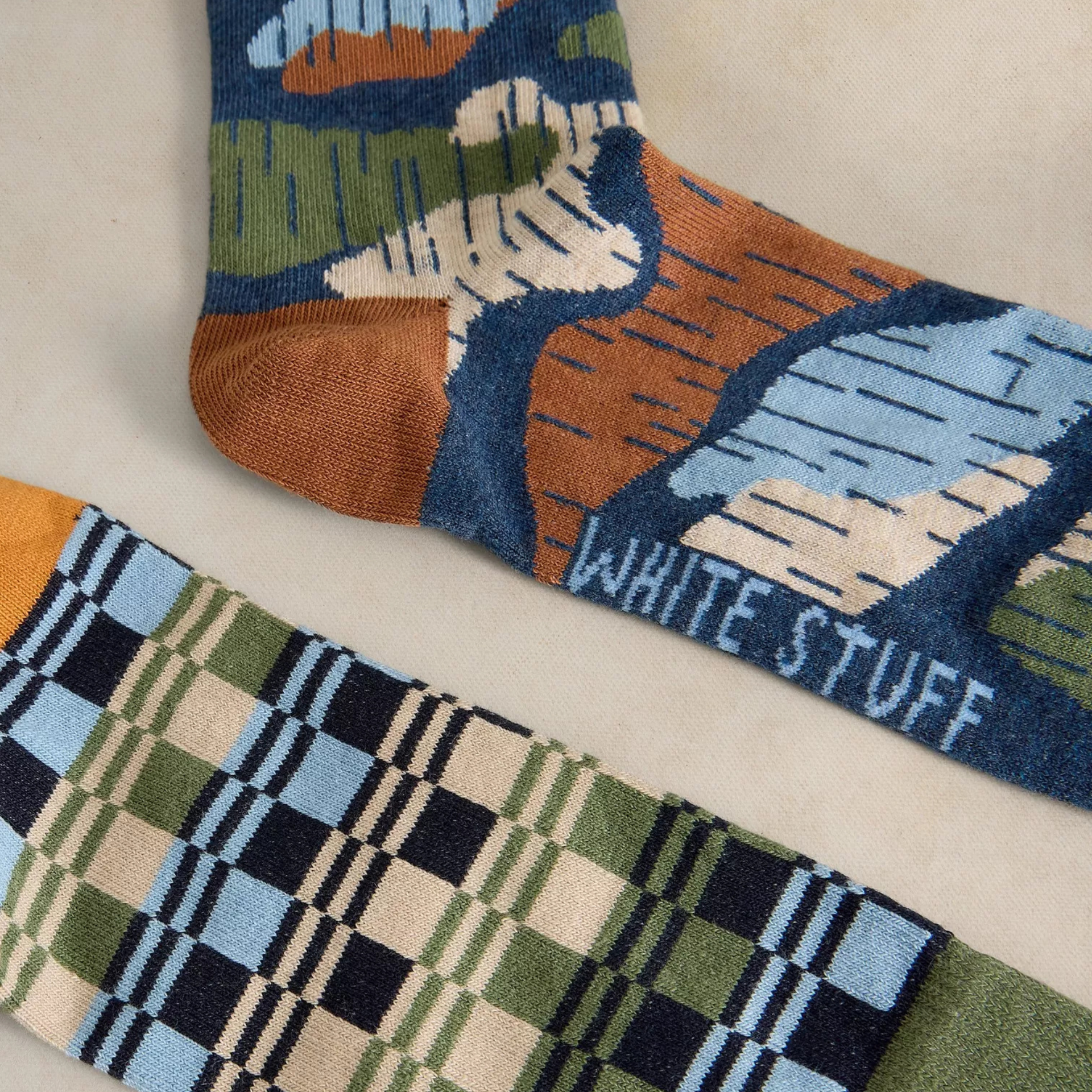 Colorful patterned socks with 'White Stuff' branding on a light background