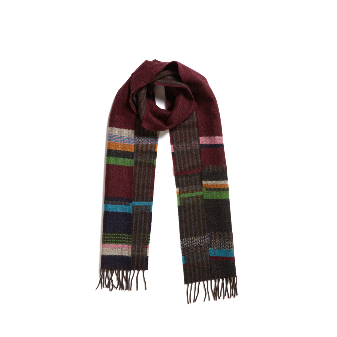 Burgundy wool scarf with multicolored woven pattern and fringed ends.