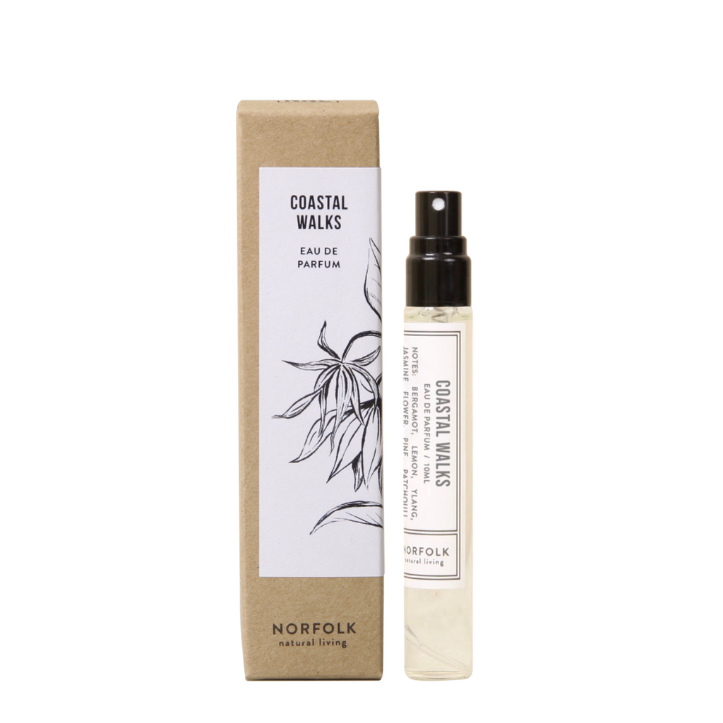 Norfolk Natural Living - Coastal Walks - Eau de Parfum atomiser bottle positioned to the right of its manila outer packaging with a black and white label