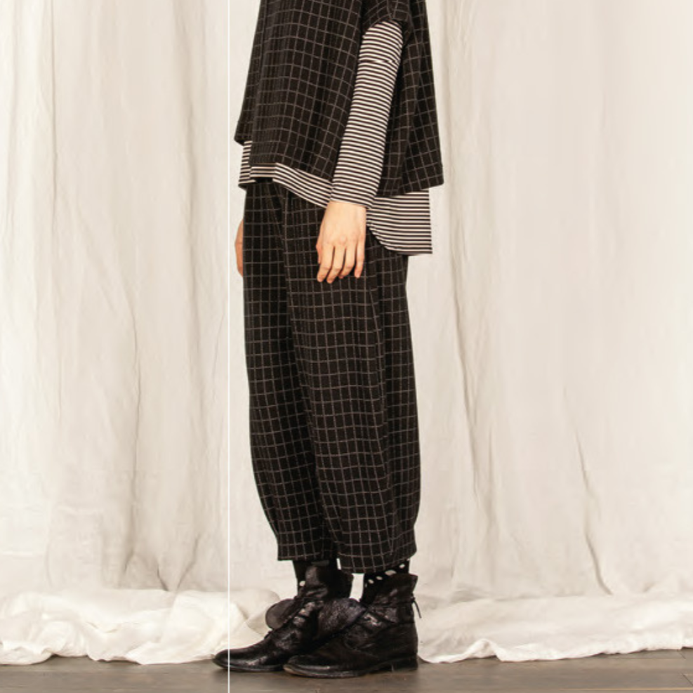 Black and white gingham cropped trousers with a loose, wide leg.  The trousers are shown paired with dark boots.