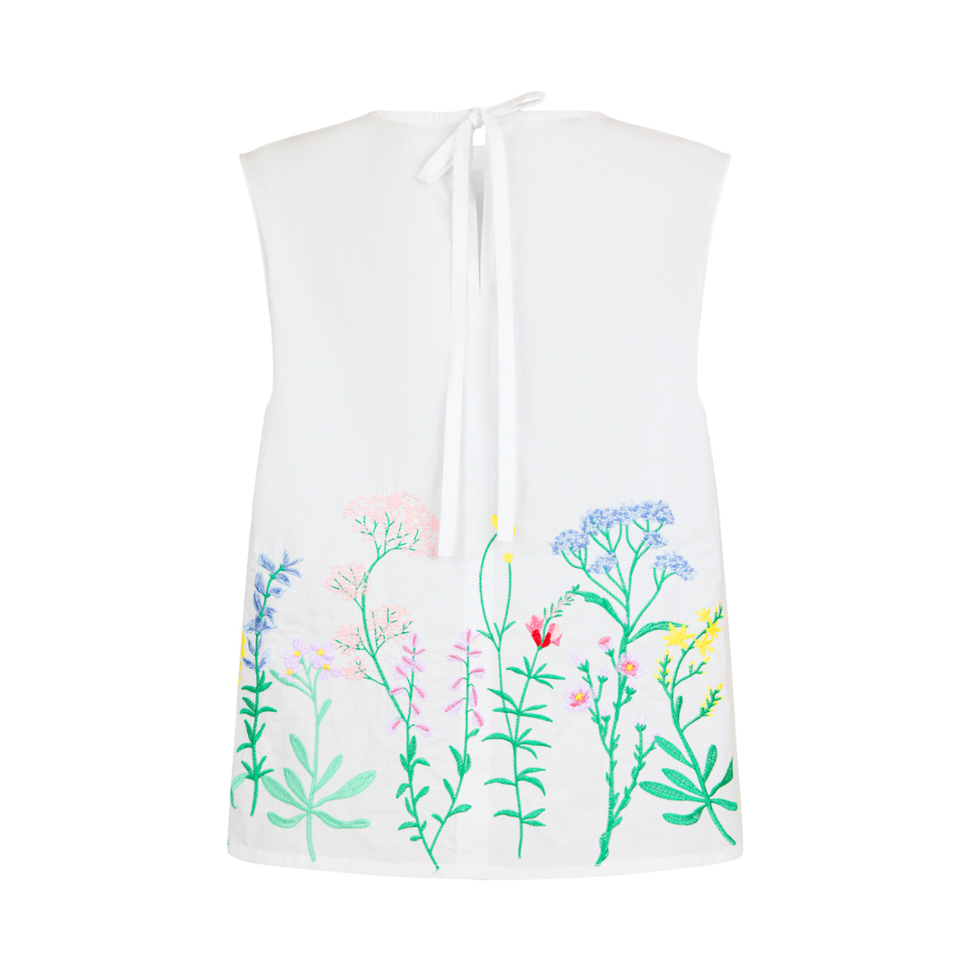 White sleeveless top with colorful floral patterns on a white background